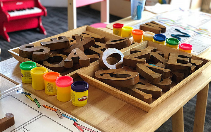 Letters cut out of wood in a tray